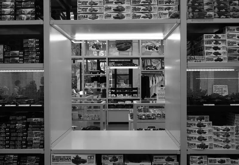 Interior view of a model kit store showing shelves filled with boxes of model kits