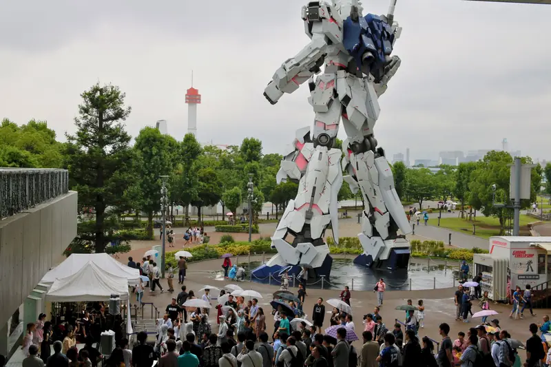 Crowd gathers around Gundam statue in Minato City, Tokyo