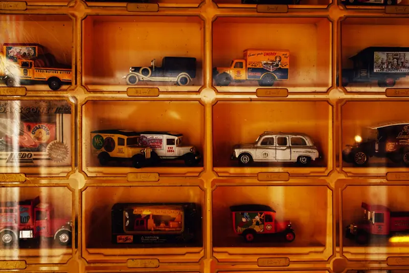 Showcase of vintage die-cast model cars in a display case, highlighting retro styles and nostalgia