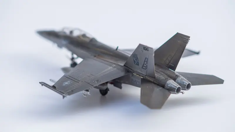 Close-up of a miniature fighter jet model on a white background