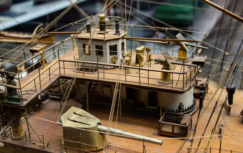 Close-up shot of a detailed historical wooden ship model, showcasing intricate craftsmanship and design