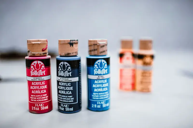 Colorful acrylic paint bottles displayed on a surface, perfect for creative art projects