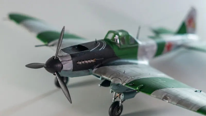 A meticulously detailed model airplane with propeller and camouflage colors